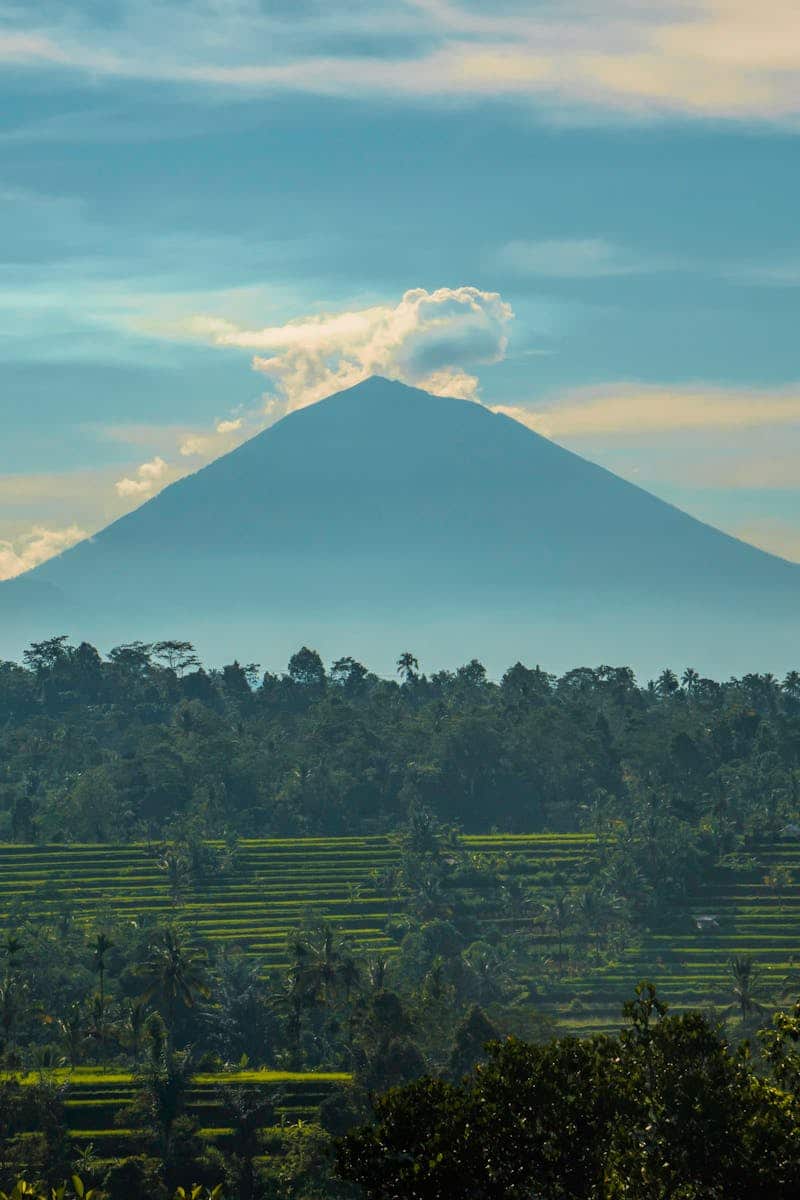 Stunning view of a volcano amidst lush greenery in Lampung, Indonesia. Perfect for nature lovers.