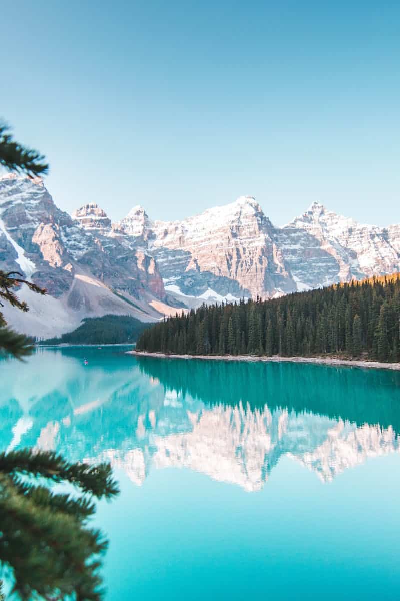 Idyllic view of Moraine Lake reflecting mountains and forests in Banff National Park, Canada.